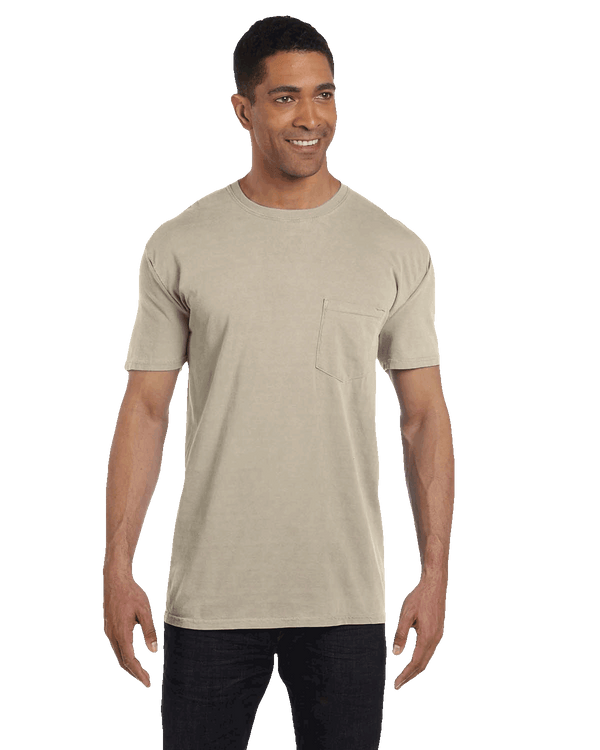 Man in a sand-colored pocket t-shirt and dark jeans, showcasing a minimalist casual outfit