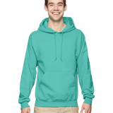 Smiling man wearing a mint green pullover hoodie with kangaroo pocket and drawstrings, paired with beige pants
