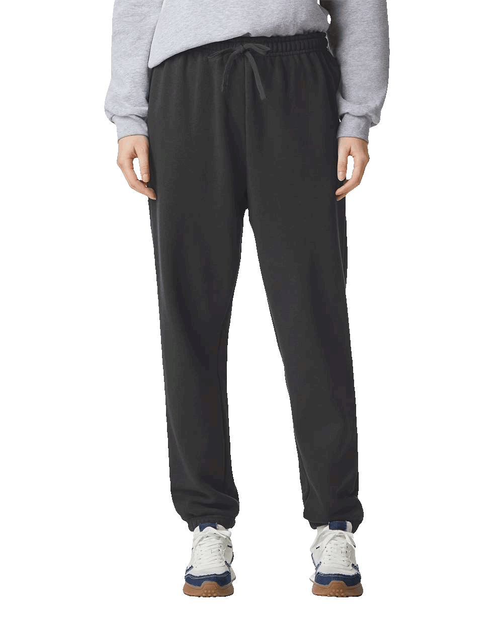 Black straight-leg sweatpants with drawstring waist and relaxed fit, styled with white and navy athletic sneakers