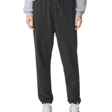 Black straight-leg sweatpants with drawstring waist and relaxed fit, styled with white and navy athletic sneakers