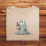 A folded vintage Comfort Colors Tshirt in Ivory White color, laying on a wooden table. The retro design features a cute bedsheet ghost holding a bottle of liquor that say Boos.
