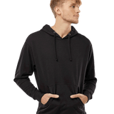 Young man in a black lightweight hoodie with front pocket and drawstrings, looking to the side with hands in pockets