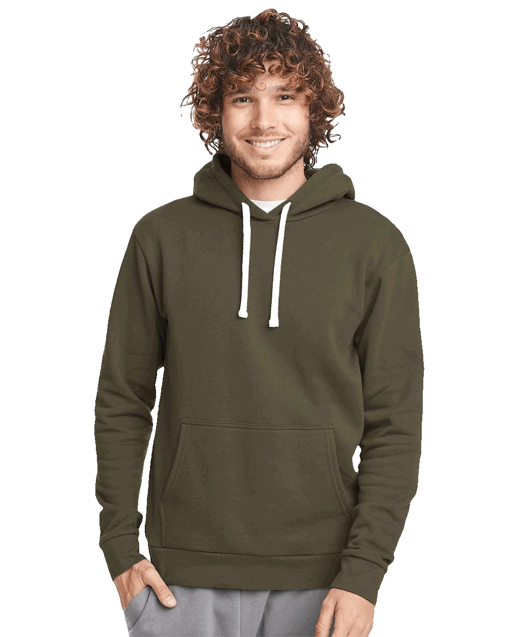 Man wearing olive green hoodie with front pocket and white drawstrings, smiling with hands in pockets