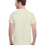 Back view of a "Natural" colored Gildan Adult Heavy Cotton T-Shirt worn by a man, standing with a neutral stance.