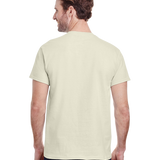 Back view of a "Natural" colored Gildan Adult Heavy Cotton T-Shirt worn by a man, standing with a neutral stance.