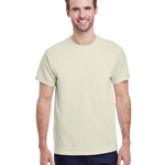 Man in a "Natural" colored Gildan Adult Heavy Cotton T-Shirt, standing with a relaxed posture and a friendly smile.