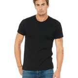 Bella + Canvas Unisex Jersey T-Shirt in black color worn by a man with tattoos on his arms, standing with a relaxed posture.