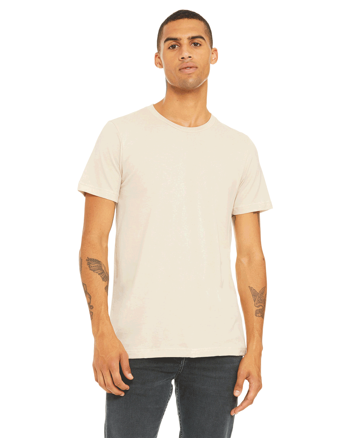 Bella + Canvas Unisex Jersey T-Shirt in "Natural" color modeled by a man with tattoos on his arms, standing casually.