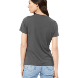 Back view of a woman modeling a Bella + Canvas Ladies' Relaxed Jersey Short-Sleeve T-Shirt in Asphalt color, highlighting the shirt's relaxed fit.