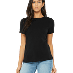 Woman wearing a Bella + Canvas Ladies' Relaxed Jersey Short-Sleeve T-Shirt in Black color, standing with a neutral expression and light blue jeans.