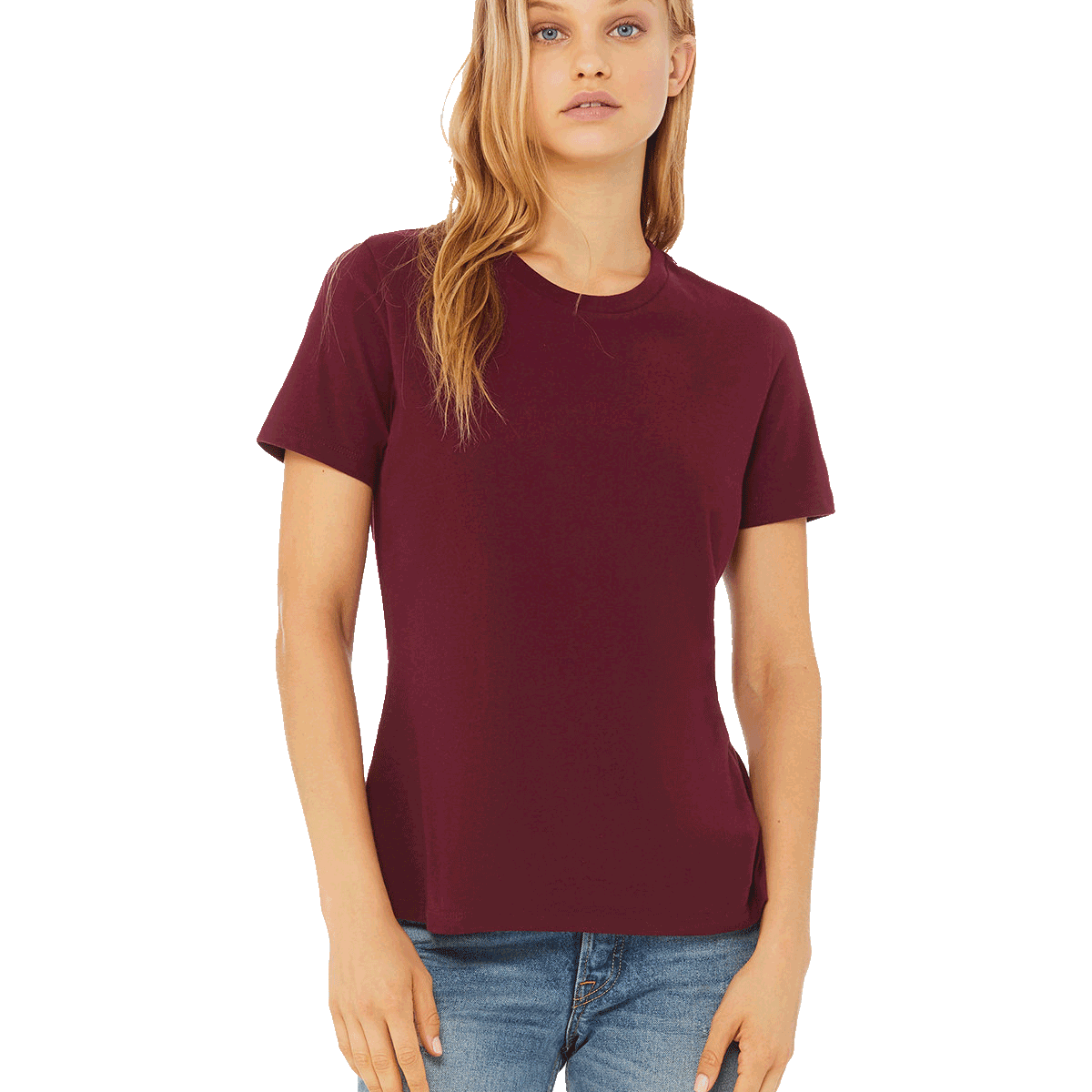 Front view of a blonde woman modeling a Bella + Canvas Ladies' Relaxed Jersey Short-Sleeve T-Shirt in the Maroon color, paired with light blue jeans.