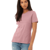 Front view of a woman modeling a Bella + Canvas Ladies' Relaxed Jersey Short-Sleeve T-Shirt in Orchid color, paired with light blue jeans.