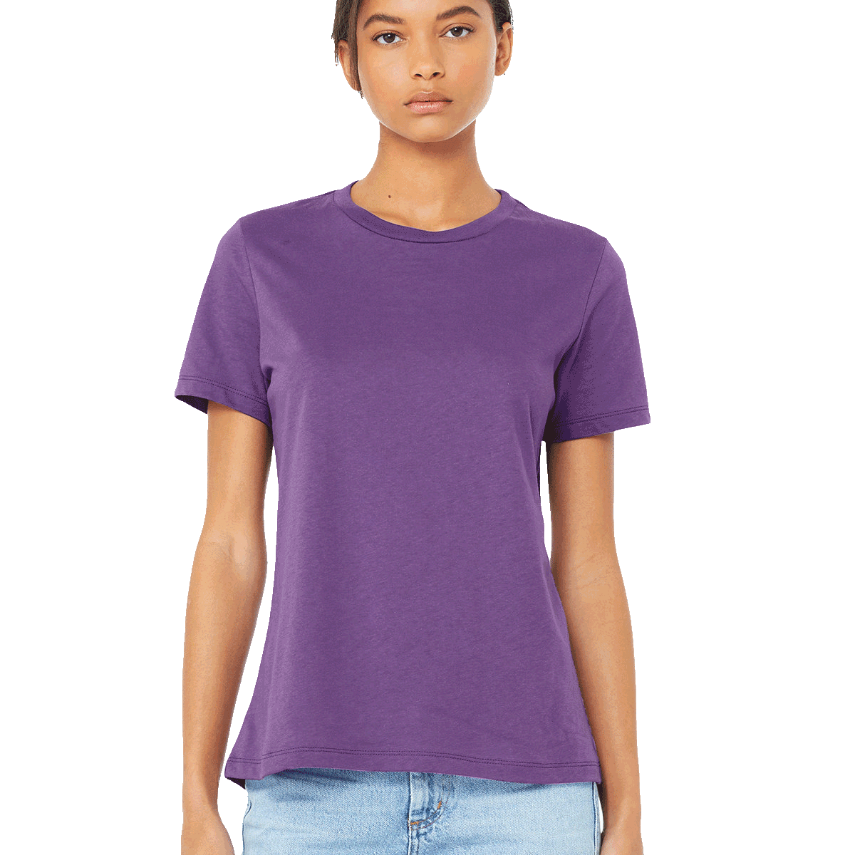 Woman wearing a Bella + Canvas Ladies' Relaxed Jersey Short-Sleeve T-Shirt in Royal Purple color, standing with a neutral expression and light blue jeans.