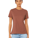 Model showcasing a Bella + Canvas Ladies' Relaxed Jersey Short-Sleeve T-Shirt in the Terracotta color, paired with light-wash jeans and a confident pose.