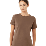 A woman in a casual Bella + Canvas Ladies' Relaxed Jersey Short-Sleeve T-Shirt in the Vintage Brown color, standing in a relaxed pose.