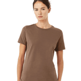 A woman in a casual Bella + Canvas Ladies' Relaxed Jersey Short-Sleeve T-Shirt in the Vintage Brown color, standing in a relaxed pose.