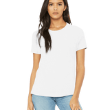 Front view of a woman modeling a Bella + Canvas Ladies' Relaxed Jersey Short-Sleeve T-Shirt in White, paired with light blue jeans.