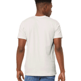 Man showing the back of a Bella + Canvas Unisex Jersey T-Shirt in "Vintage White" color, standing casually with hands by his sides.