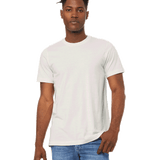 Man wearing a Bella + Canvas Unisex Jersey T-Shirt in "Vintage White" color, standing with a relaxed posture and hand resting on his side.