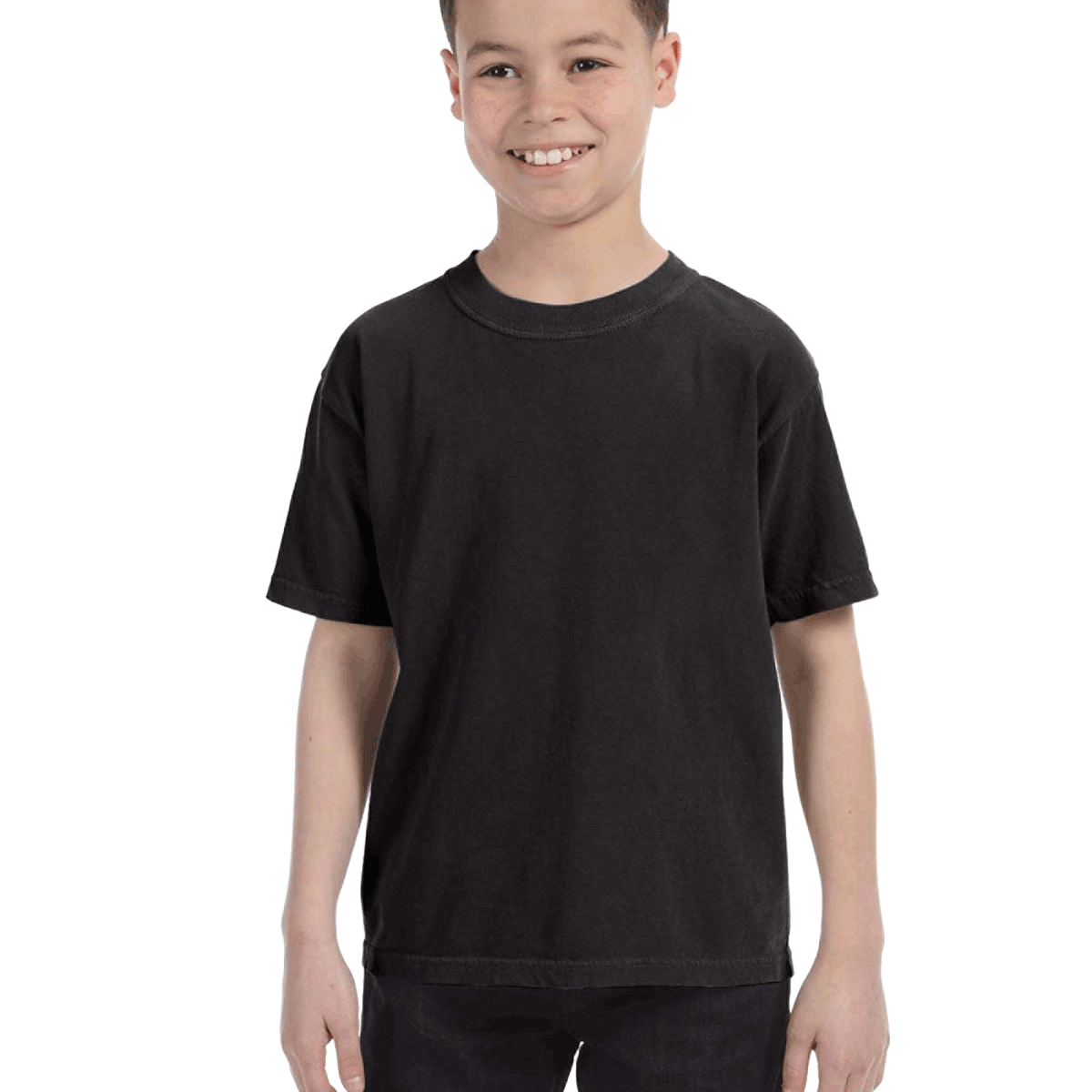 Young boy modeling a Comfort Colors Youth Midweight T-Shirt in "Black" color, standing with a cheerful expression.