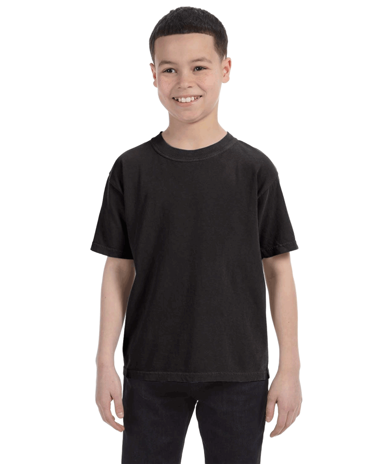 Young boy modeling a Comfort Colors Youth Midweight T-Shirt in "Black" color, standing with a cheerful expression.