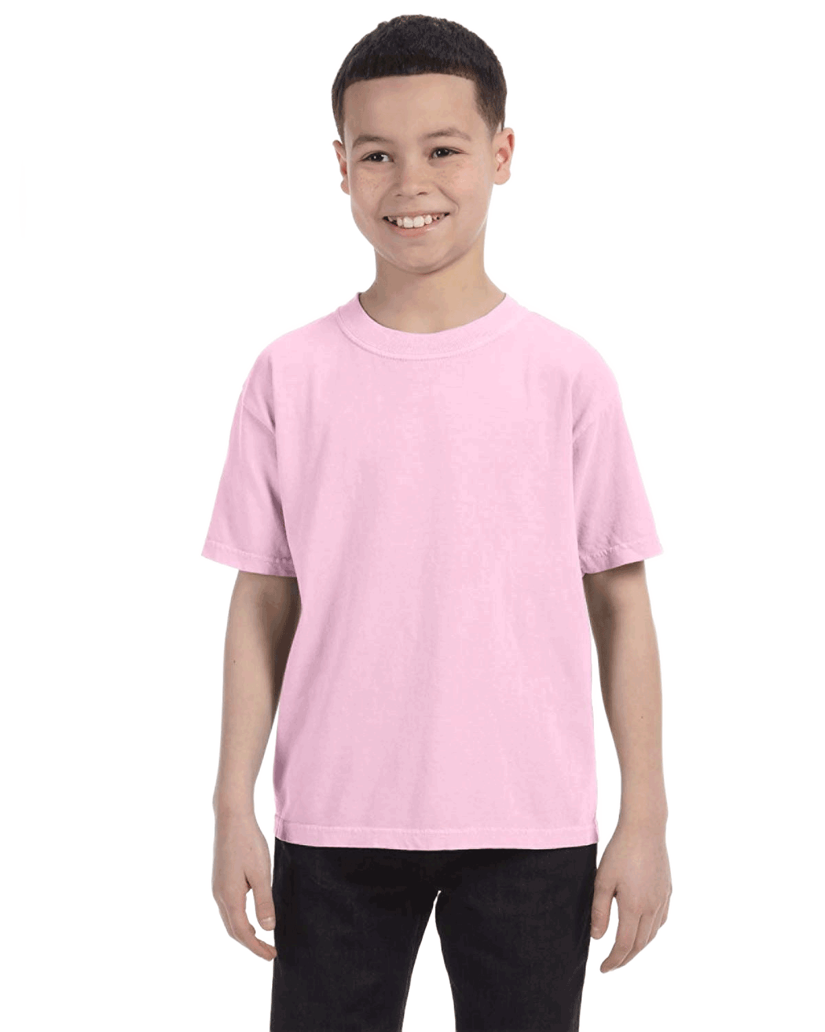 Smiling boy wearing a Comfort Colors Youth Midweight T-Shirt in "Blossom" color, with hands by his sides.