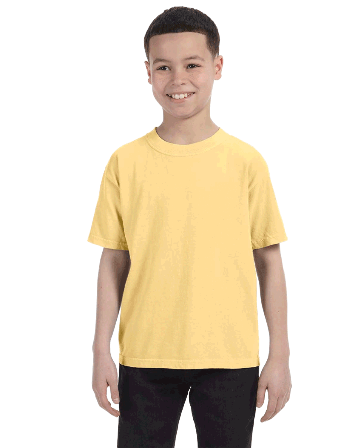 Smiling boy wearing a Comfort Colors Youth Midweight T-Shirt in "Butter" color, with hands by his sides.