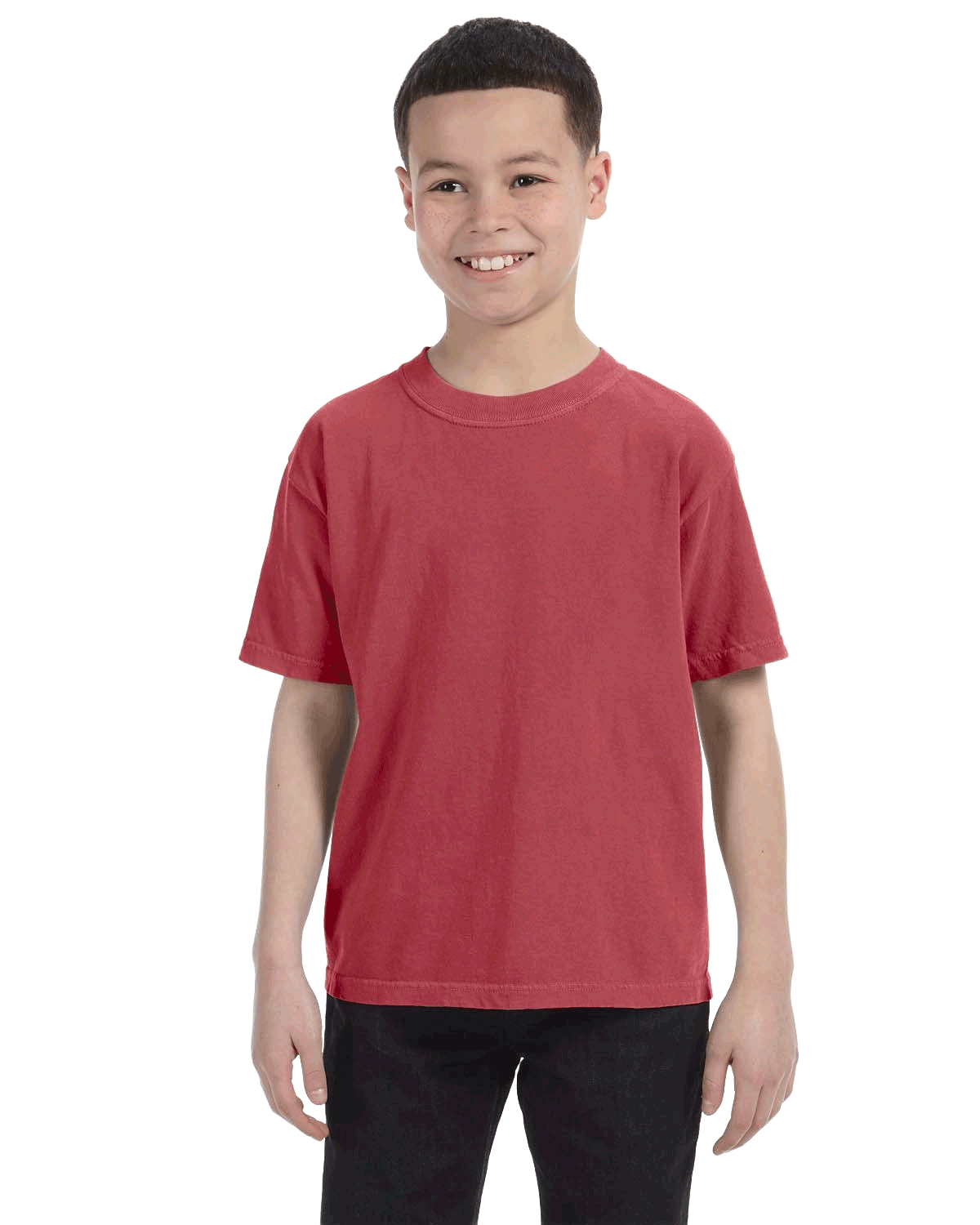 Young boy modeling a Comfort Colors Youth Midweight T-Shirt in "Crimson" color, standing with a cheerful expression.