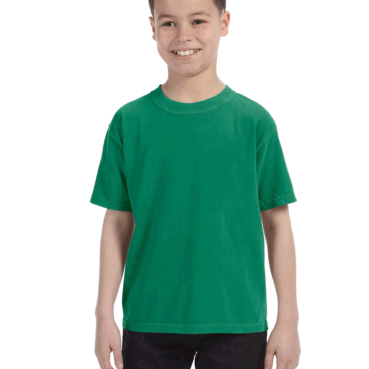 Comfort Colors Youth Midweight T-Shirt in "Grass" color worn by a smiling boy standing with hands relaxed.