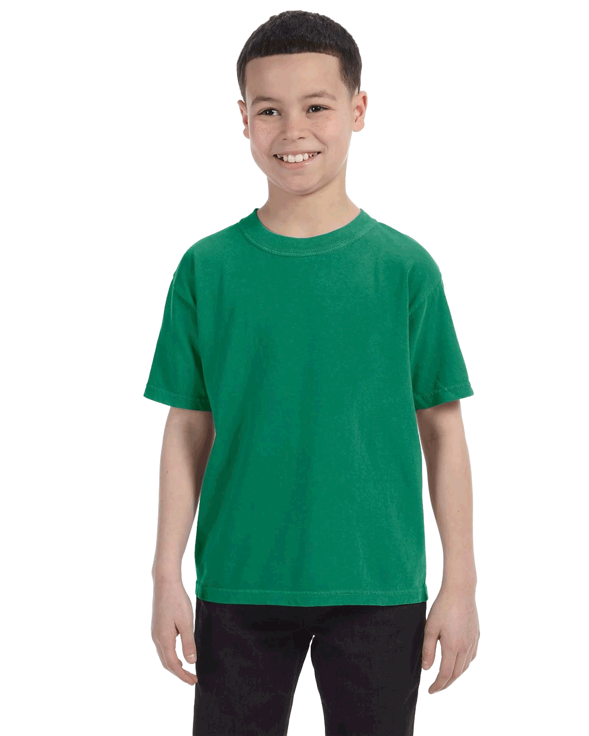 Comfort Colors Youth Midweight T-Shirt in "Grass" color worn by a smiling boy standing with hands relaxed.