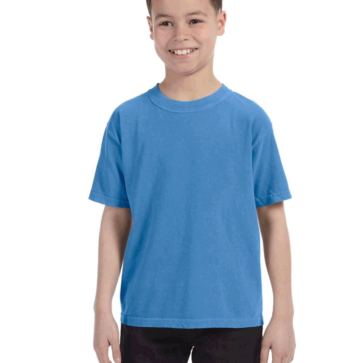 Young boy modeling a Comfort Colors Youth Midweight T-Shirt in "Royal Caribe" color, standing with a cheerful expression.