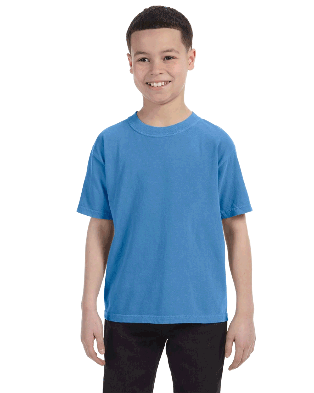 Young boy modeling a Comfort Colors Youth Midweight T-Shirt in "Royal Caribe" color, standing with a cheerful expression.