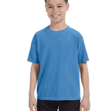 Young boy modeling a Comfort Colors Youth Midweight T-Shirt in "Royal Caribe" color, standing with a cheerful expression.