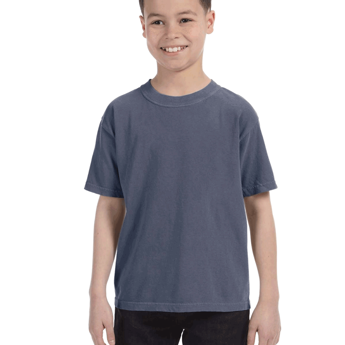 Child in a "Washed Denim" colored Comfort Colors Youth Midweight T-Shirt, smiling while standing with hands relaxed by his sides.