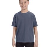 Child in a "Washed Denim" colored Comfort Colors Youth Midweight T-Shirt, smiling while standing with hands relaxed by his sides.