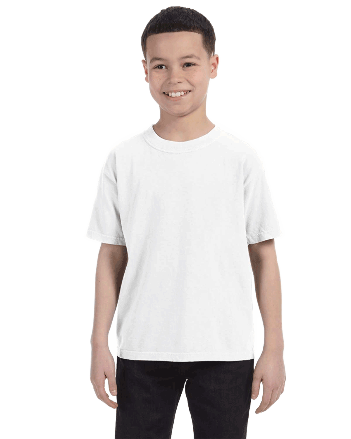 Child in a "White" colored Comfort Colors Youth Midweight T-Shirt, smiling while standing with hands relaxed by his sides.