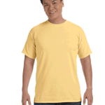 Man wearing a Comfort Colors Heavyweight T-Shirt in "Butter" color, smiling while standing with hands by his sides.