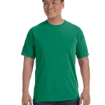 Man wearing a Comfort Colors Heavyweight T-Shirt in "Grass" color, smiling while standing with hands by his sides.