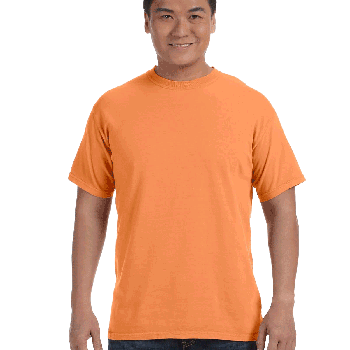 Man wearing a Comfort Colors Heavyweight T-Shirt in "Melon" color, smiling with hands relaxed by his sides.