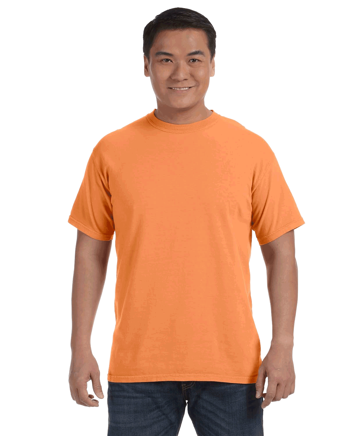 Man wearing a Comfort Colors Heavyweight T-Shirt in "Melon" color, smiling with hands relaxed by his sides.