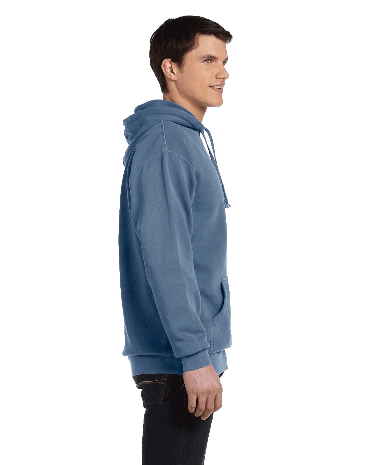 Side view of a man wearing a Comfort Colors Heavyweight Hoodie in Blue Jean, showing the relaxed fit and front pocket. The model is smiling.