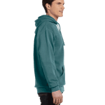Profile view of a man in a Blue Spruce Comfort Colors Heavyweight Hoodie, showcasing the side details with a relaxed fit.