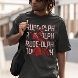 A model wearing a vintage baggy grey comfort colors shirt. The retro design features Rudolph the Red Nosed Reindeer in a y2k merch artstyle, posed in a rude manner. There is text that says Rude-olph, a funny pun with his name to go with the graphic