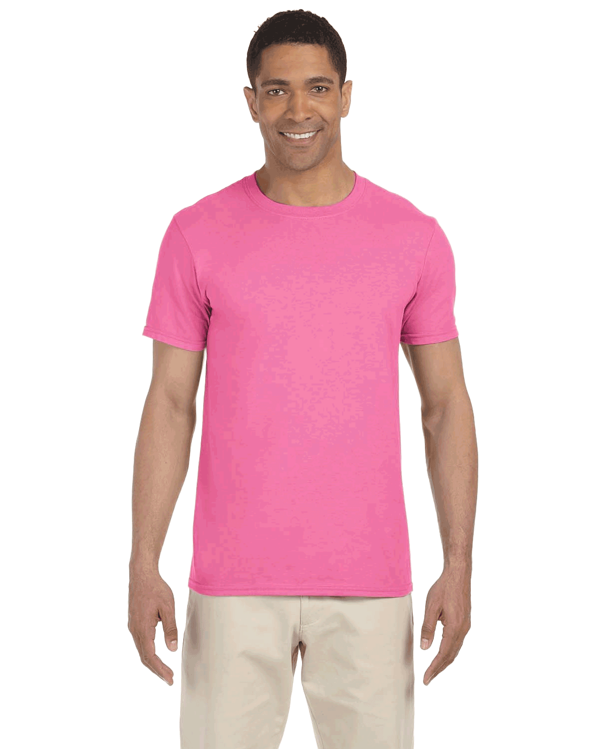 Man wearing a Gildan SoftStyle T-shirt in "Azalea" color, standing with a relaxed posture and smiling.