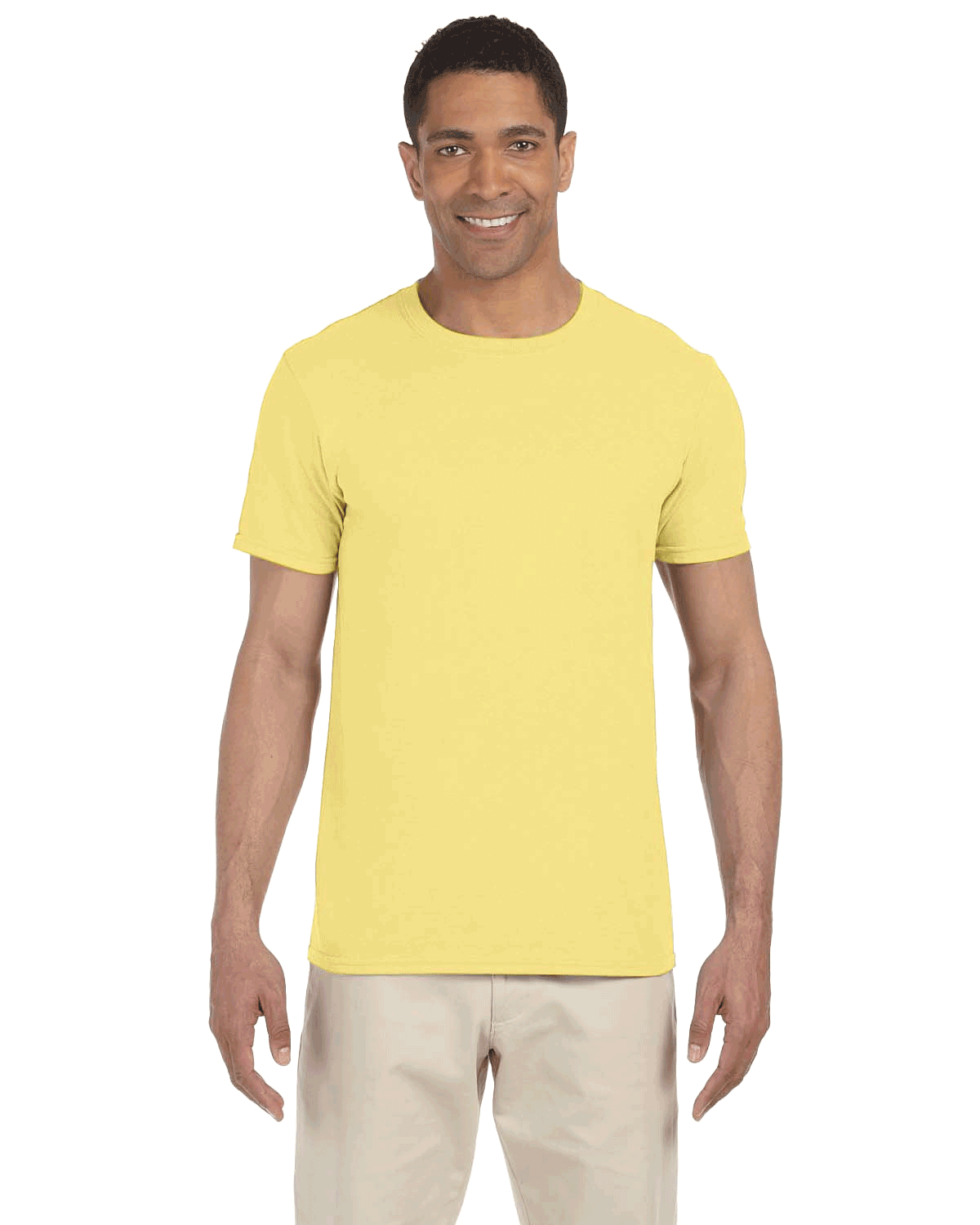 Gildan SoftStyle T-shirt in "Cornsilk" color worn by a man, standing casually with a cheerful expression.