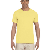 Gildan SoftStyle T-shirt in "Cornsilk" color worn by a man, standing casually with a cheerful expression.