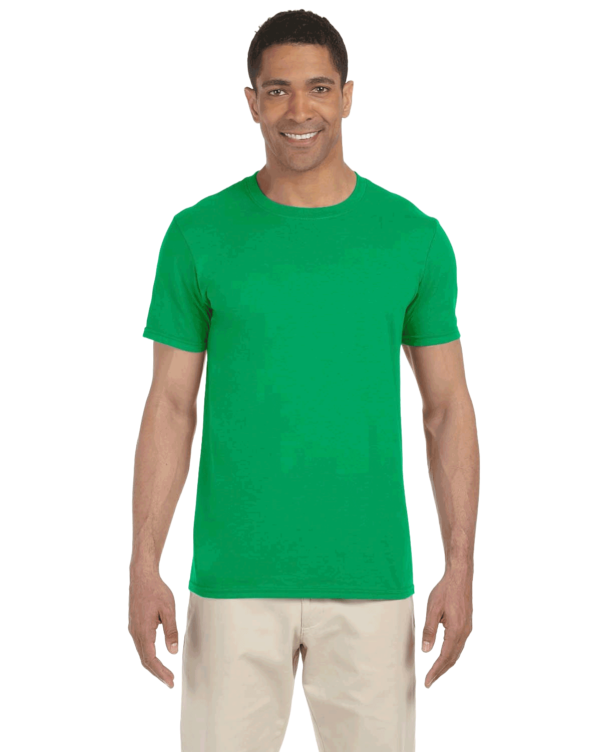 Man wearing a Gildan SoftStyle T-shirt in "Irish Green" color, standing with a relaxed posture and smiling.