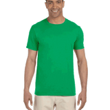 Man wearing a Gildan SoftStyle T-shirt in "Irish Green" color, standing with a relaxed posture and smiling.