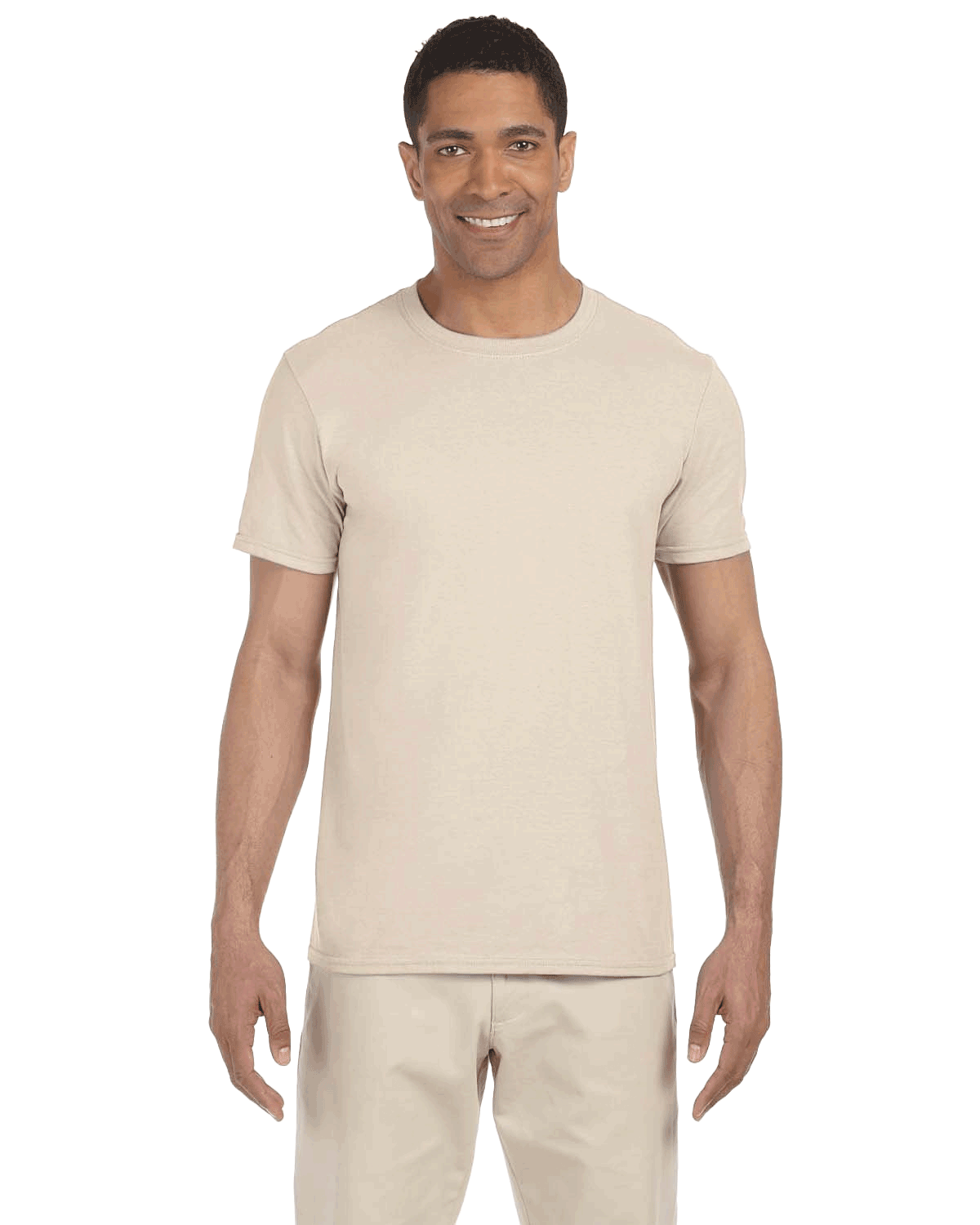 Man wearing a Gildan SoftStyle T-shirt in "Natural" color, standing with a relaxed posture and smiling.