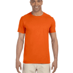 Man in a "Orange Sunset" colored Gildan SoftStyle T-shirt, standing with a relaxed posture and a friendly smile.